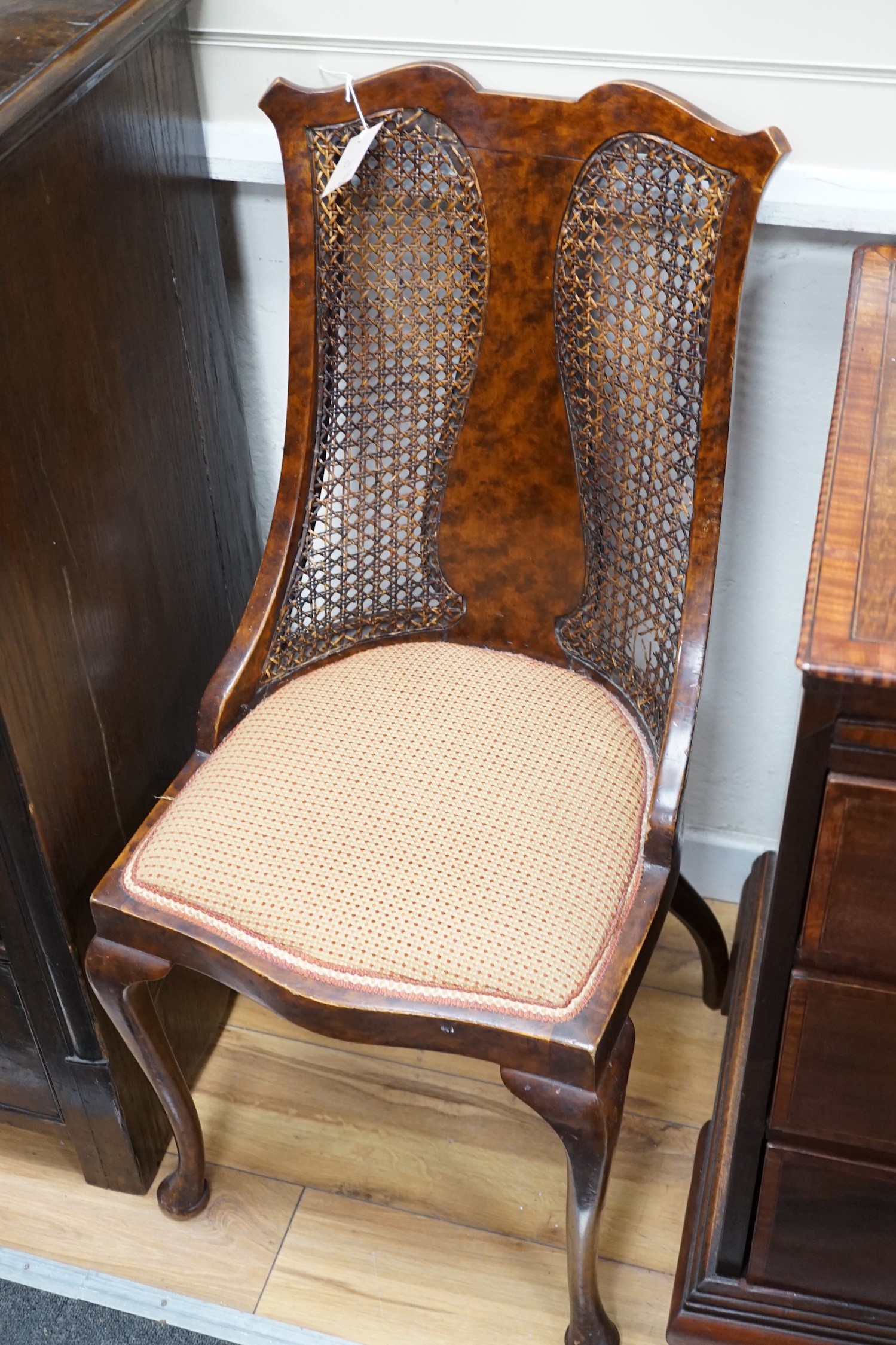 An Edwardian mahogany nursing chair and a 1930's caned walnut occasional chair *Please note the sale commences at 9am.